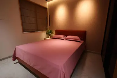 a pink bed with two pink pillows in a room at The Nova Heights in Kozhikode