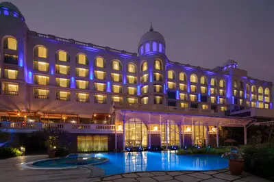 a large building with blue lights on it at Radisson Blu Plaza Hotel Mysore in Mysore