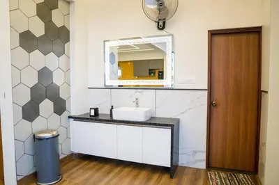 a bathroom with a sink and a mirror at Bumblebee - The Penthouse in Mysore