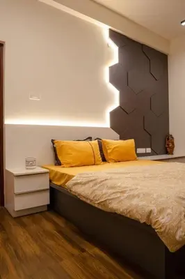 a bedroom with a bed with yellow pillows on it at Bumblebee - The Penthouse in Mysore