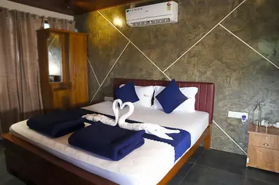 a bedroom with two swans towels on a bed at Mannath Private Pool Villas at Vellarimala in Wayanad