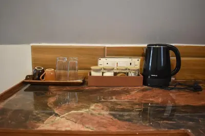 a coffeemaker and a coffee maker on a counter at IInfinity Kodaikanal in Kūkkāl