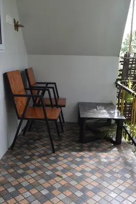 two chairs and a table in a room at IInfinity Kodaikanal in Kūkkāl