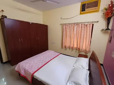 a bedroom with a bed and cabinets and a window at Unwind @ Serene Retreat in Palakkad