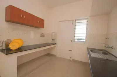a kitchen with a sink and a counter top at ThulasiRams Service Apartments in Coimbatore