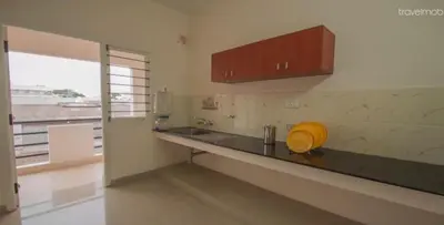 a kitchen with a yellow object on the counter at ThulasiRams Service Apartments in Coimbatore