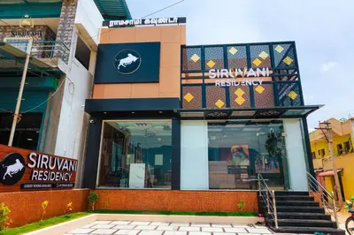 a building with a sign on the front of it at Siruvani Residency - Near Isha Foundation Coimbatore in Alāndurai