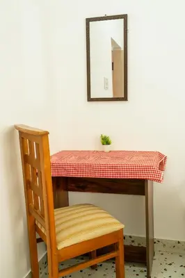 a table with a potted plant on top of it at Maya Homez - Coimbatore in Coimbatore