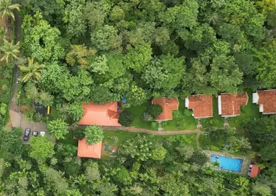 an overhead view of a forest with houses and trees at Le Vista Resort in Sultan Bathery
