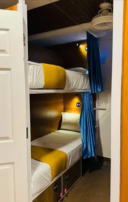 a room with three bunk beds in it at LOWFARE HOTELS in Kozhikode