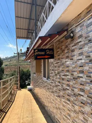 a sign on the side of a brick building at Serene Hills in Ooty
