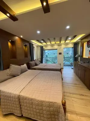 a large bedroom with two beds in it at Serene Hills in Ooty