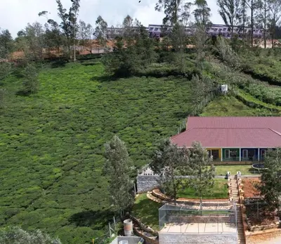 an aerial view of a house on a hill at Coastal Grand Resorts - Akshaya in Kotagiri