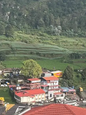 a group of houses with red roofs on a hill at Hill Resort - 2 in Ooty