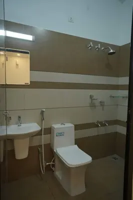 a bathroom with a toilet and a sink at Home stay - Near Cochin Airport in Angamali