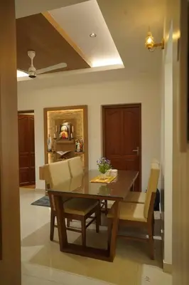 a dining room with a wooden table and chairs at Home stay - Near Cochin Airport in Angamali