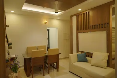 a living room with a table and chairs and a couch at Home stay - Near Cochin Airport in Angamali