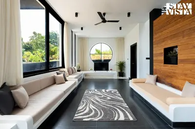 a living room with a long couch and large windows at StayVista at Lotus Lumiere with Breakfast & jacuzzi in Madikeri