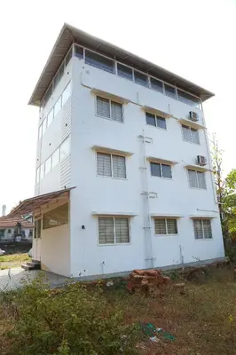a white building with a lot of windows at Shoreline in Kozhikode