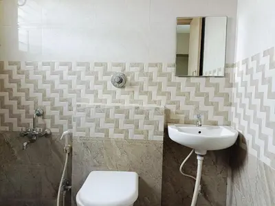 a bathroom with a sink and a toilet at 2BHK Flat by SR Renton Comfort Homestay Mysore @ Vijayanagar 2nd stage Mysore in Mysore
