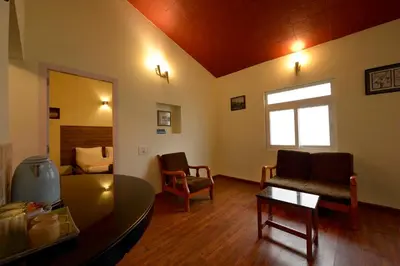 a living room with a couch and a table at Sabol Holidays in Ooty