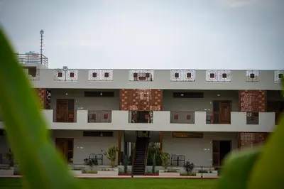 an external view of an apartment building with windows at Poojaris Nirantara - Mysuru in Hampāpura