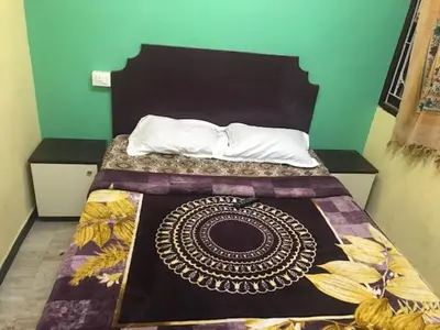 a bedroom with a bed with a bedspread on it at Le Apex misty stay in Ooty