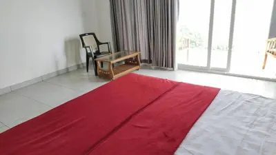 a room with a red and white rug and a chair at Mist View Resort Wayanad in Wayanad