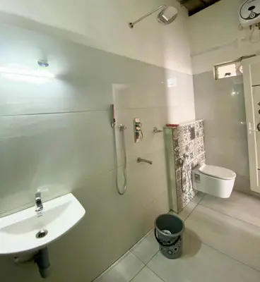 a bathroom with a sink and a toilet and a shower at Mist View Resort Wayanad in Wayanad