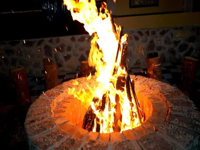 a large fire pit with flames in it at The Jade Highlands Mountain View Container Studio Room in Kodaikānāl