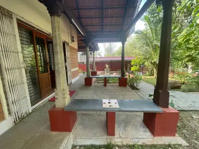 a bench sitting in front of a building at 'Vrindavan' in Heritage City Mysuru in Mysore