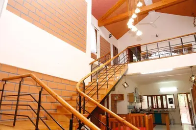 a wooden staircase in a building with a staircase at 'Vrindavan' in Heritage City Mysuru in Mysore