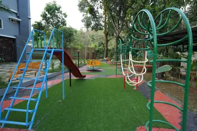 a playground with a slide in a park at M!steria Inn in Wayanad
