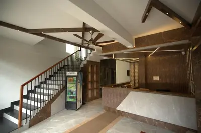 a lobby with a staircase and a vending machine at Sreeja Myst in Athirappilly