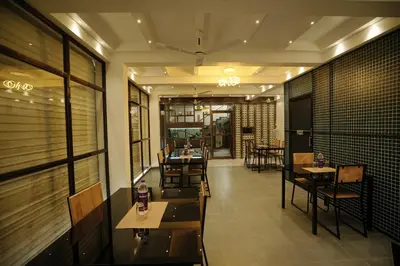 a dining room with tables and chairs in a restaurant at Sreeja Myst in Athirappilly