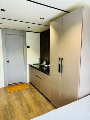 a room with a kitchen with a sliding door at The Jade Highlands Mountain View Cozy container 2bhk villa in Kodaikānāl