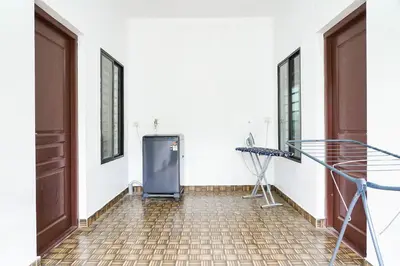 a room with a heater in the corner of a building at Adam homes in Alwaye