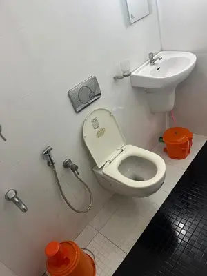a bathroom with a toilet and a sink at THEStay in Alwaye