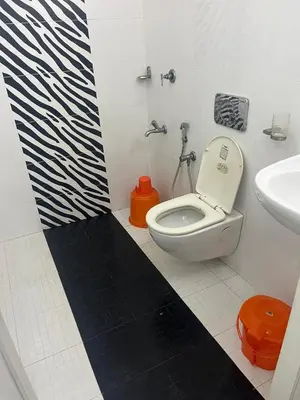 a bathroom with a toilet and a sink at THEStay in Alwaye