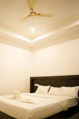 a bedroom with a large bed with a ceiling at Karickanattu Nature Resort in Idukki