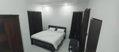 a small bedroom with a bed and a mirror at Kashmir Valley in Kanthalloor