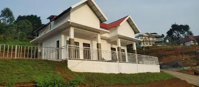 a house sitting on top of a hill at Kashmir Valley in Kanthalloor