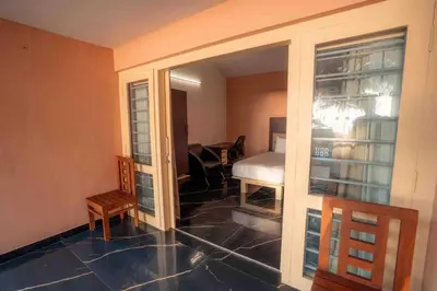 a room with a room with a door to a bedroom at Baywatch by Grha - A Picturesque Beachfront Villa in Kozhikode