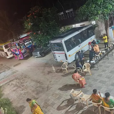a group of people sitting in chairs in front of a food truck at Aryas Residency- Near Isha Foundation Coimbatore & Adiyogi statue in Alāndurai