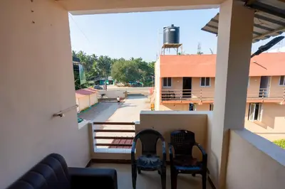 a balcony with chairs and a view of a street at Aryas Residency- Near Isha Foundation Coimbatore & Adiyogi statue in Alāndurai