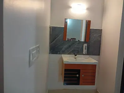 a bathroom with a sink and a mirror at Eden Homestays in Wayanad