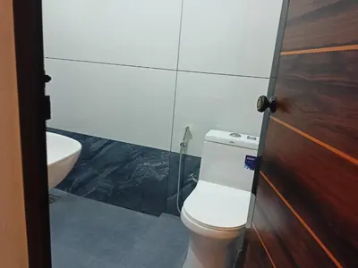 a bathroom with a toilet and a sink at Eden Homestays in Wayanad