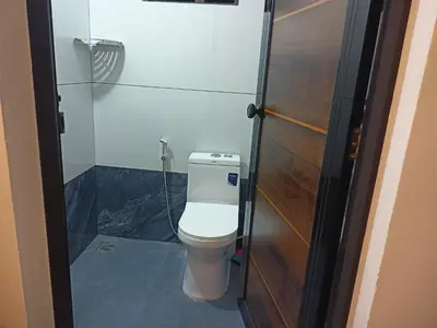a small bathroom with a toilet in a room at Eden Homestays in Wayanad