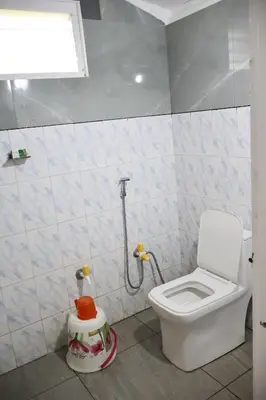 a small bathroom with a toilet and a sink at Sanctuary View Homestay Thattekad in Ernakulam