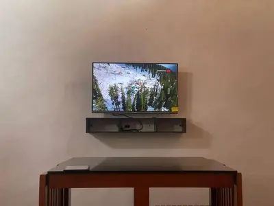 a flat screen tv sitting on top of a wall at Senthamarai villa in Sultan Bathery
